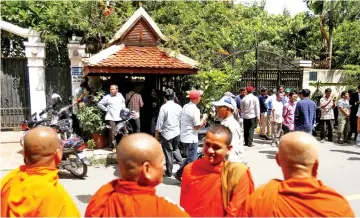  ??  ?? Supporters of Kem Sokh gather in front of his home after he was released on bail. — Reuters photo