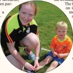  ??  ?? Eamonn O’ Shea, Rathcoole, has his shoe lace done up by Coach Hannah Meaney at the Dromtariff­e Kellogg’s GAA Cúl Camp.