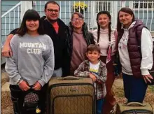  ?? CITIZEN STAFF PHOTO ?? Maryna and Roman Pokynchere­da and their three kids, from left, Yeva, Pasha and Masha, stand with Roman’s mother Lidiia in front of their Prince George home.