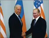  ?? ALEXANDER ZEMLIANICH­ENKO — THE ASSOCIATED PRESS FILE ?? Then-Vice President Joe Biden, left, shakes hands with Russian leader Vladimir Putin in Moscow, Russia, on March 10, 2011.