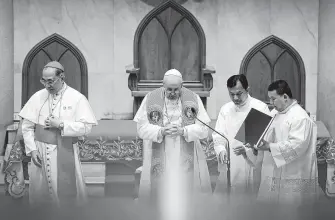  ?? Manish Swarup / Associated Press ?? Pope Francis, center, offers prayers at Saint Peter’s Parish in Thailand. Francis, 82, has made trips to 11 countries this year, spending nearly a month on the road in the process.