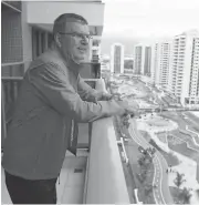  ?? IVAN ALVARADO-POOL/GETTY IMAGES ?? IOC president Thomas Bach looks from his balcony after moving into the Olympic village in Rio de Janeiro.