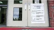  ?? STAFF PHOTO BY C.B. SCHMELTER ?? A sign outlining safety measures hangs on the door at Leroy Massey Elementary School on Tuesday in Summervill­e, Ga.