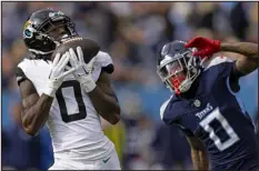  ?? WADE PAYNE — ASSOCIATED PRESS FILE ?? Jacksonvil­le Jaguars wide receiver Calvin Ridley catches a pass in front of Tennessee Titans cornerback Sean Murphy-bunting on Jan. 7in Nashville, Tenn.