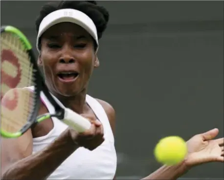  ?? THE ASSOCIATED PRESS ?? Venus Williams of the United States returns to Belgium’s Elise Mertens during their women’s singles match on the opening day at the Wimbledon Tennis Championsh­ips in London.