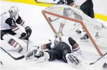  ?? TERRY RENNA/AP ?? Arizona Coyotes defenseman Luke Schenn and goalie Mike Smith try in vain to keep Shawn Thornton’s shot from crossing the line.