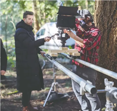  ?? — AMAZING FACTORY ?? Production designer and composer Cayne McKenzie, left and photograph­y director Joseph Schweers work on director/writer Andrew Huculiak's short film SARS-COV-2 in Surrey's Crescent Park.