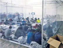  ??  ?? SO SAD: A day after pictures from this Texas facility were leaked, the Biden administra­tion released its own shots of unaccompan­ied migrant kids crammed close to each other and this toddler lying on a mat looking up at a man (above).