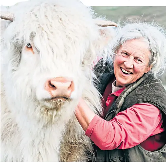  ?? Picture: Andrew Cawley ?? Rosie Douglas with Molly the Highland cow at Glendearg Farm, near Galashiels