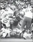  ?? CP PHOTO ?? Toronto Argonauts’ Jim Stillwagon, centre, holds up a wall of Winnipeg Blue Bombers to stop ball carrier John Bledsoe (30) during CFL action in Toronto on July 10, 1974. Stillwagon has passed away at the age of 68.