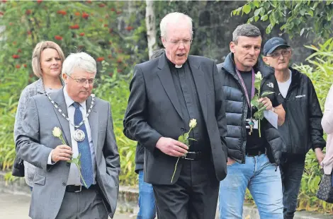  ??  ?? Heavily involved North Lanarkshir­e Provost Tom Castles (left) and Father Vincent were among the guests