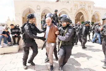  ?? — AFP photo ?? Israeli police detain a man during clashes following a visit by a group of Jewish people at the al-Aqsa mosque compound which is the site of Islam’s third-holiest place and of Judaism’s holiest site, known to Jews as the Temple Mount, in the Old City of Jerusalem.
