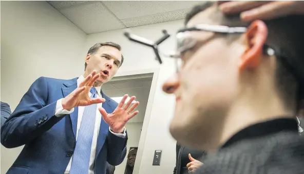  ?? ARLEN REDEKOP/PNG ?? Federal Finance Minister Bill Morneau, in town to discuss his 2018 budget, is given a demonstrat­ion of transcrani­al magnetic stimulatio­n (TMS) at UBC Hospital’s Koerner Pavilion in Vancouver on Tuesday.