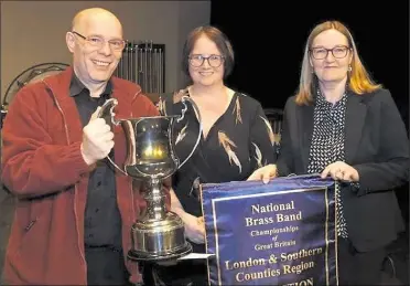  ?? ?? Musical director Andy Collins collects the trophy