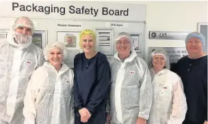  ??  ?? Members of the packing team at AstraZenec­a with recovering cancer patient Sue Vincent (second left)