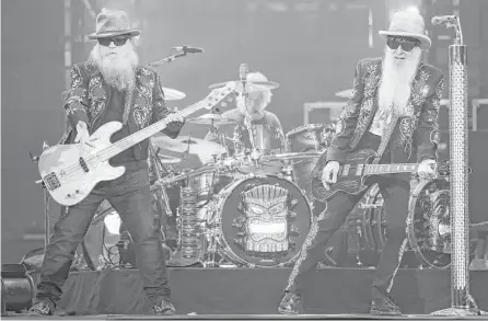  ?? Michael Ciaglo / Houston Chronicle ?? Texas rockers ZZ Top kept the RodeoHoust­on crowd energized with wailing guitars, sparkling blazers and gravelly sounds.