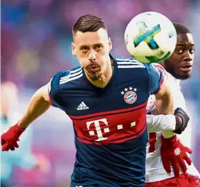  ??  ?? Hang on there: Leipzig defender Dayot Upamecano (right) vying for the ball with Bayern Munich forward Sandro Wagner during the Bundesliga match at the Red Bull Arena on Sunday. — AFP