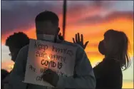  ?? STEVE GRIFFIN— ASSOCIATED PRESS ?? In this Oct. 13, 2020, file photo, family members of inmates incarcerat­ed in the Utah Department of Correction­s’ prison system hold candles and say a prayer following a rally outside the Department of Correction­s office in Draper, Utah.