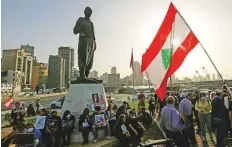  ?? Photo credit ?? Families of the 2020 port explosion victims hold pictures during a protest near Beirut port, Lebanon, on April 4.