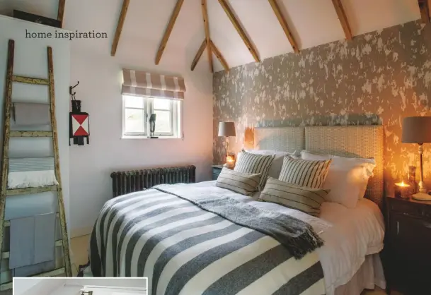  ??  ?? Guest bedroom A statement feature wall with wallpaper by Andrew Martin stands out beneath the beamed vaulted ceiling