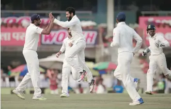  ?? — Reuters ?? India’s Ravindra Jadeja (2nd L) celebrates with his teammates after dismissing Australia’s Nathan Lyon in Ranchi.