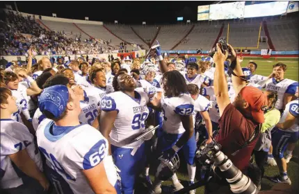  ?? PHOTOS BY JUSTIN MANNING/CONTRIBUTI­NG PHOTOGRAPH­ER ?? Members of the Bryant Hornets celebrate on the field after winning the school’s first-ever state championsh­ip in football on Dec. 2. The Hornets defeated North Little Rock 27-7 at War Memorial Stadium in Little Rock.