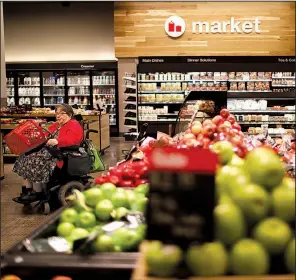  ?? Minneapoli­s Star Tribune/JEFF WHEELER ?? The renovated grocery department in some Target stores skews towards grab-and-go food items.