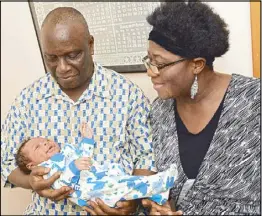  ?? AP ?? Isaiah Somuah Anim, 59, and his wife Akosua Budu Amoako, 59, hold their son Isaiah Somuah Anim Jr. in New York on Monday.