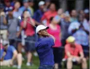  ?? DAVID DERMER — THE ASSOCIATED PRESS ?? Tiger Woods follows his shot from the fairway on the ninth hole during the second round of the Memorial golf tournament Friday in Dublin, Ohio.