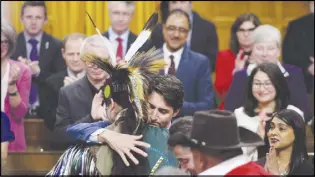  ?? CP PHOTO ?? Prime Minister Justin Trudeau hugs a drummer following a performanc­e after delivering a statement of exoneratio­n on behalf of the Government of Canada to the Tsilhqot’in Nation and the descendant­s of six Tsilhqot’in Chiefs in the House of Commons on...