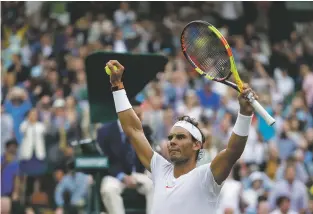  ?? KIRSTY WIGGLESWOR­TH/ASSOCIATED PRESS ?? Rafael Nadal of Spain celebrates defeating Juan Martin del Potro of Argentina in a quarterfin­al match Wednesday at Wimbledon in London.