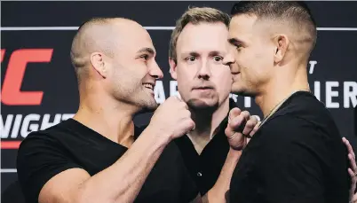  ?? JEFF McINTOSH/THE CANADIAN PRESS ?? Eddie Alvarez, left, and Dustin Poirier get up close and personal as they prepare to square off in their UFC lightweigh­t bout at the Saddledome today.