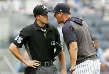  ?? KATHY WILLENS — THE ASSOCIATED PRESS ?? New York Yankees’ Aaron Boone, right, gets in the face of home plate umpire Brennan Miller during the second inning of game one of a doublehead­er against the Tampa Bay Rays, Tuesday in New York. Boone had already been ejected when he expressed his displeasur­e with the umpire’s calls.