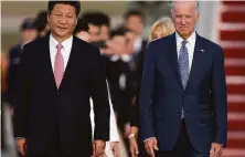  ?? Carolyn Kaster / Associated Press 2015 ?? Then Vice President Joe Biden welcomes Chinese President Xi Jinping at Andrews Air Force Base, Md., during his 2015 visit.