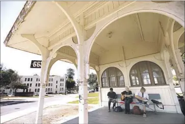  ?? Photograph­s by Genaro Molina Los Angeles Times ?? VETERANS David Bunche, left, Joey Meece and Jeremy Spear spend time at the historic Trolley House that will remain as part of the new Town Center on the Veteran Affairs West L.A. campus.