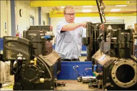  ?? STAFF ?? Eric Schoen, an Emerson technician, works in the assembly lab at the facility in Sidney.