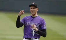  ?? David Zalubowski, The Associated Press ?? Colorado Rockies starting pitcher Jeff Hoffman chats with teammates before putting on a face mask as the team practices in Coors Field on Saturday.