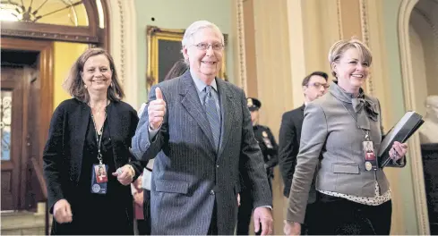  ??  ?? HAS THE NUMBERS: Senate Majority Leader Senator Mitch McConnell, centre, gives a thumbs up in Capitol Hill on Friday.