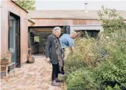  ?? ?? Christine Magid and her son, Ben, at the home she shares with him and his family in north London. Built around a garden, the home allows three generation­s of family members to look out for one another without sacrificin­g privacy.