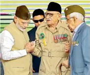  ?? PTI ?? Prime Minister Narendra Modi with INA veteran Lalti Ram during a flag hoisting ceremony to mark the 75th anniversar­y of the Azad Hind government, at Red Fort in New Delhi, on Sunday. —