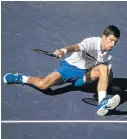  ?? TPN/GETTY IMAGES Picture: ?? SLIPPING AWAY: Novak Djokovic of Serbia falls while hitting a forehand against Philipp Kohlschrei­ber of Germany, in the Paribas Open at Indian Wells, California, on Tuesday.