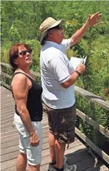  ?? TNS ?? Gail and Peter O’Donovan of Park Ridge, Ill., check out the flora and fauna in Audubon Corkscrew Swamp Sanctuary in Naples, Fla.