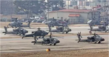  ?? KWON JUNE-WOO/YONHAP VIA AP ?? U.S. Army Apache helicopter­s prepare to take off Monday at Camp Humphreys in Pyeongtaek, South Korea.