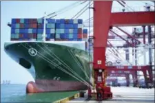  ?? CHINATOPIX VIA AP ?? A ship hauls containers at a container port in Qingdao in eastern China’s Shandong province Friday. The United States hiked tariffs on Chinese imports Friday and Beijing said it immediatel­y retaliated in a dispute between the world’s two biggest...
