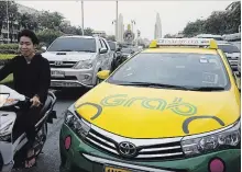  ?? BRENT LEWIN BLOOMBERG FILE PHOTO ?? Toyota’s outlay in Southeast Asia’s largest car-hailing service, Grab, is double the size of General Motors’ investment in Lyft in 2016.