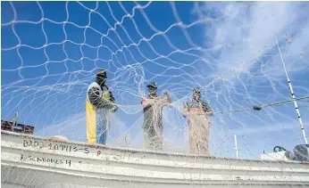  ??  ?? NET INTEREST: Fishermen prepare their nets at Campo Serena fishing camp in the Gulf of California, near Puertecito­s, 90 kilometres south of San Felipe in Baja California state, northweste­rn Mexico.