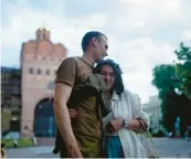  ?? ?? Newlywed stand-up comics Serhiy Lipko and Anastasia Zukhvala embrace Saturday on their wedding day in Kyiv. The army gave Lipko, soon to be deployed, a day off to tie the knot.