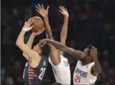  ?? SETH WENIG — THE ASSOCIATED PRESS ?? Knicks forward Kevin Knox (20), left, drives through Los Angeles Clippers defenders during the first half of an NBA basketball game, Sunday in New York.