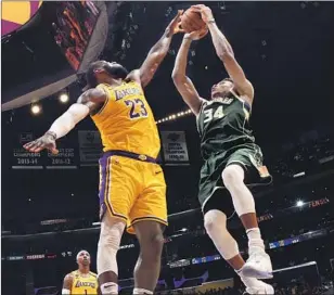  ?? Andrew D. Bernstein NBAE vi a Getty I mages ?? THE MARCH 6 game between the Lakers and LeBron James, left, and the Milwaukee Bucks and Giannis Antetokoun­mpo at a sold- out Staples Center was a marquee NBA matchup.