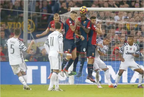  ?? — AFP ?? Juventus’ Miralem Pjanic (left) scores during the Serie A match against Genoa at the Luigi Ferraris Stadium in Genoa.